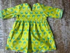 66e7f9d48cfc6900b2a088a3_lg Yellow Frock Adorned With Blue And Green Motifs